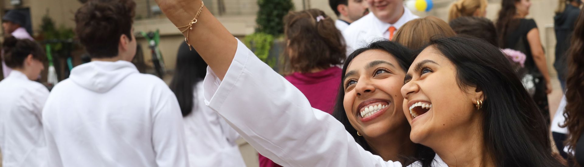 two students taking a selfie in their White Coats