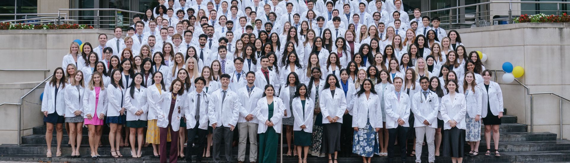 Students in their White Coats on the steps of Gelman Library